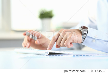 Male arms hold credit card press buttons Male arms hold credit card press buttons 106173532