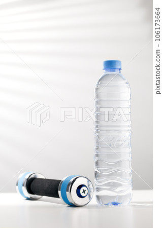 Dumbbells and bottled water. Dumbbells and bottled water. 106173664