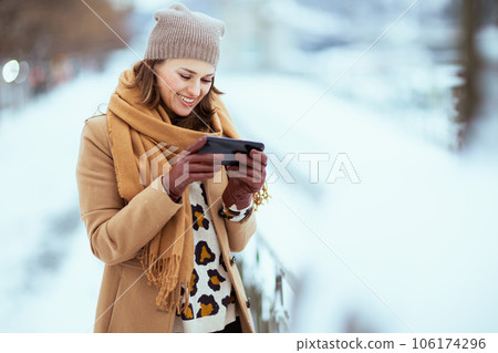 smiling elegant female using smartphone applications smiling elegant female using smartphone applications 106174296
