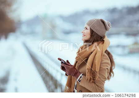 smiling elegant woman sending text message using smartphone 106174298