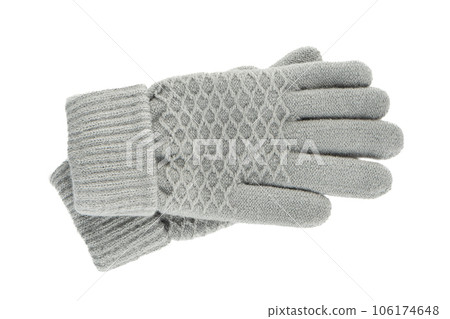 A pair of women's knitted gloves isolated on a white background. A pair of women's knitted gloves isolated on a white background. 106174648