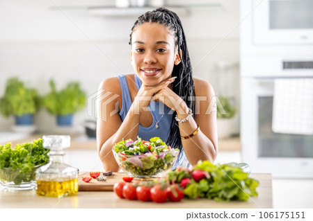 A good looking afro american girl prepared a healthy mixed salad of fresh vegetables A good looking afro american girl prepared a healthy mixed salad of fresh vegetables 106175151