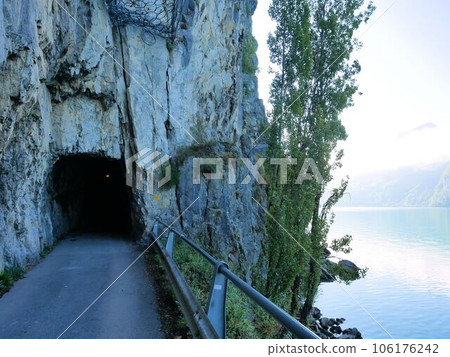 Hiking route along Lake Wallen Tunnel through rocks (St.Gallen, Switzerland) 106176242