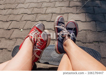 Red and blue sneakers shoes on a feet. Sneakers shoes Couple. Red and blue sneakers shoes on a feet. Sneakers shoes Couple. 106176447