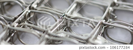 Background of many metal folder fasteners or bindings. 106177284