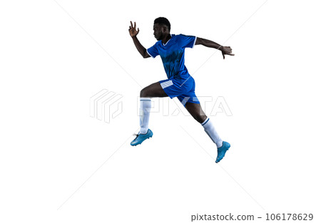 Isolated football player plays with soccerball in a match Isolated football player plays with soccerball in a match 106178629