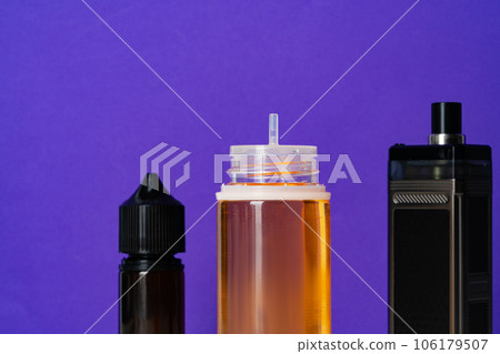 Electronic cigarettes liquid bottles on purple background 106179507