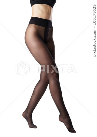 Legs of a woman in black capron tights on white background 106179529