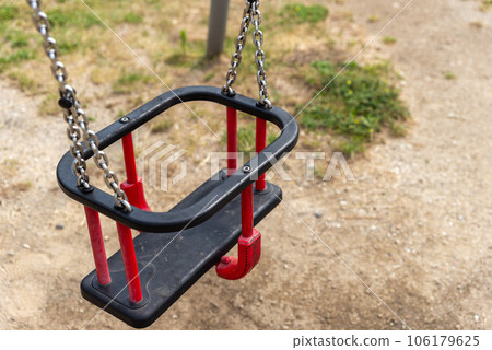 red swing on a children's playground, modern 106179625