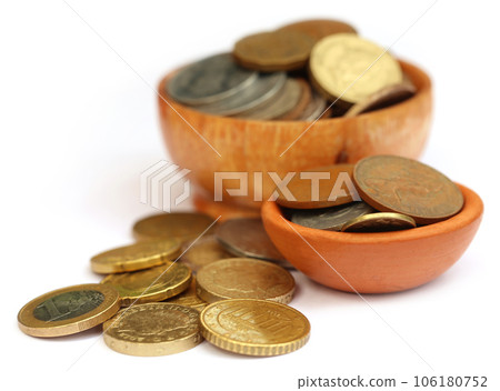 Old coins arranged in bowls 106180752