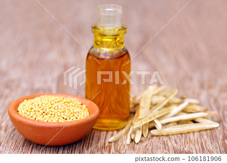 Golden Mustard with empty pods and oil in a bottle Golden Mustard with empty pods and oil in a bottle 106181906