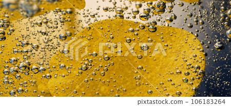 Deep fried potato chips under golden oil water. Frying rounded potatoes chip with hot boiling oil bubbles. Fast food and snack. Underwater cooking oily french fries or potatos chips in oils background 106183264