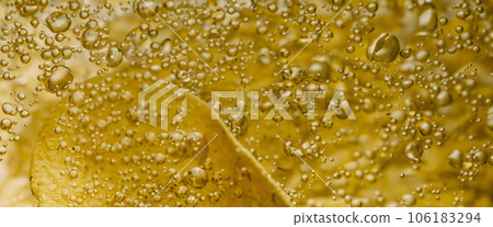 Deep fried potato chips under golden oil water. Frying rounded potatoes chip with hot boiling oil bubbles. Fast food and snack. Underwater cooking oily french fries or potatos chips in oils background 106183294