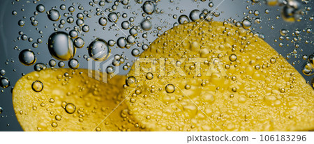 Deep fried potato chips under golden oil water. Frying rounded potatoes chip with hot boiling oil bubbles. Fast food and snack. Underwater cooking oily french fries or potatos chips in oils background Deep fried potato chips under golden oil water. Frying rounded potatoes chip with hot boiling oil bubbles. Fast food and snack. Underwater cooking oily french fries or potatos chips in oils background 106183296