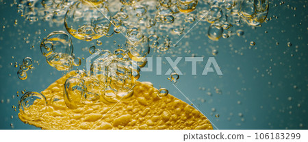 Deep fried potato chips under golden oil water. Frying rounded potatoes chip with hot boiling oil bubbles. Fast food and snack. Underwater cooking oily french fries or potatos chips in oils background Deep fried potato chips under golden oil water. Frying rounded potatoes chip with hot boiling oil bubbles. Fast food and snack. Underwater cooking oily french fries or potatos chips in oils background 106183299