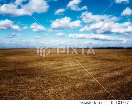 Beautiful blue sky over farm fields on a sunny day, aerial view. Landscape. Beautiful blue sky over farm fields on a sunny day, aerial view. Landscape. 106183787