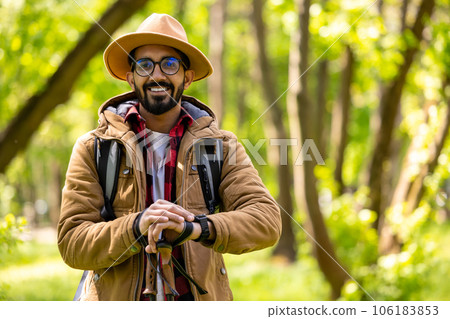 Young man on ahiking in the forest with scandinavian sticks 106183853