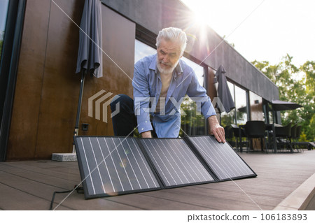 Caucasian man with solar panel innovation technology alternative energy. 106183893