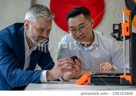 Innovative industrial engineers using 3D printer to build complex component. Innovative industrial engineers using 3D printer to build complex component. 106183900