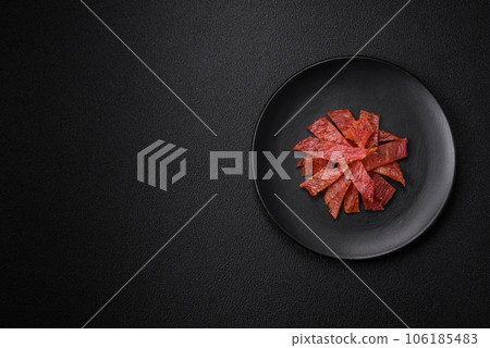 Delicious dried veal or turkey jerky with salt, spices and herbs Delicious dried veal or turkey jerky with salt, spices and herbs 106185483