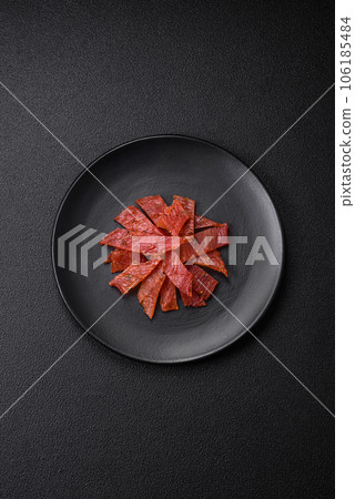 Delicious dried veal or turkey jerky with salt, spices and herbs Delicious dried veal or turkey jerky with salt, spices and herbs 106185484