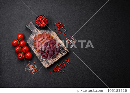 Delicious dried veal or turkey jerky with salt, spices and herbs 106185516