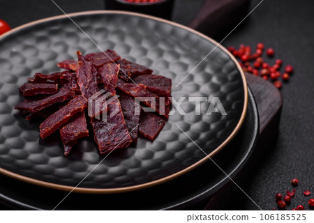 Delicious dried veal or turkey jerky with salt, spices and herbs 106185525