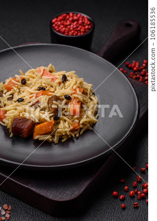 Delicious Uzbek pilaf with chicken, carrots, barberry, spices and herbs 106185536