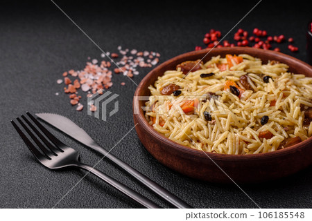 Delicious Uzbek pilaf with chicken, carrots, barberry, spices and herbs 106185548
