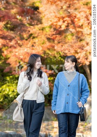 A woman enjoying autumn leaves 106185594