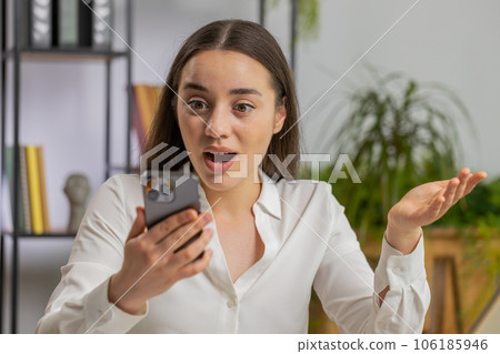 Businesswoman shocked by sudden victory on smartphone game winning lottery goal achievemen good news 106185946