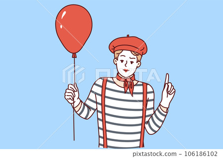 Mime man holding red balloon and pointing finger up, participating in pageant or circus 106186102