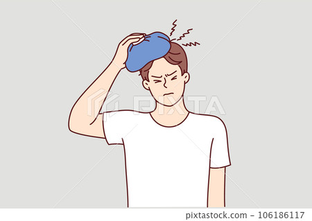 Man suffers from hangover and applies ice pack to head, feeling headache after alcohol party Man suffers from hangover and applies ice pack to head, feeling headache after alcohol party 106186117