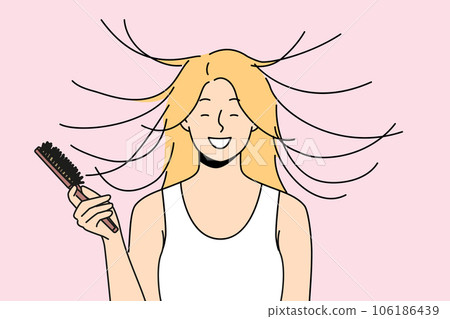 Woman combs hair and smiles, seeing effect of static magnetization of hairstyle. 106186439