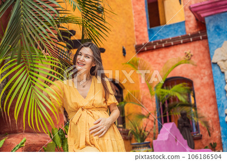 A strong and resilient woman over 40 embraces the beauty of childbirth in Mexico, celebrating the journey of motherhood with cultural richness 106186504
