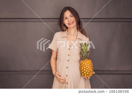 A pregnant woman's belly, beautifully showcasing the size of her baby, likened to a pineapple. Explore the potential benefits and harms of pineapple during pregnancy and childbirth A pregnant woman's belly, beautifully showcasing the size of her baby, likened to a pineapple. Explore the potential benefits and harms of pineapple during pregnancy and childbirth 106186598