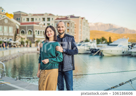 Couple in love tourists enjoying the views of Architecture and luxury yachts in Lustica Bay, Montenegro. Travel around Montenegro concept. Go Everywhere 106186606