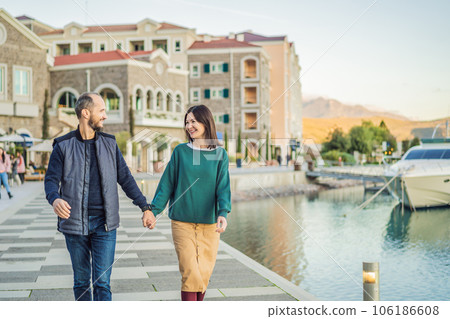 Couple in love tourists enjoying the views of Architecture and luxury yachts in Lustica Bay, Montenegro. Travel around Montenegro concept. Go Everywhere 106186608