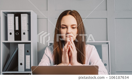 Professional crisis. Freelance thinking. Pensive concentrated business woman focused on project sitting at desk with laptop considering new idea at office workplace. Professional crisis. Freelance thinking. Pensive concentrated business woman focused on project sitting at desk with laptop considering new idea at office workplace. 106187634