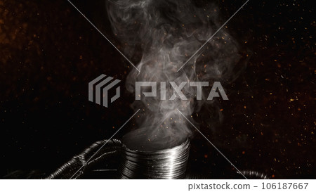 Burn smoke. Fire sparks floating. Global warming. White chemical fume ash flying over flexible exhaust duct pipe on dark black abstract empty space background. 106187667