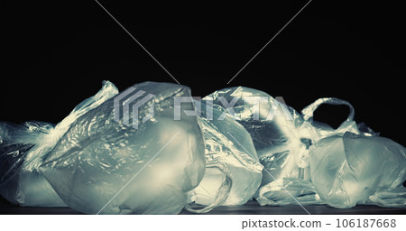 Waste collection. Plastic recycling. Environmental pollution. Blown polyethylene packets litter pile isolated on black background empty space. 106187668