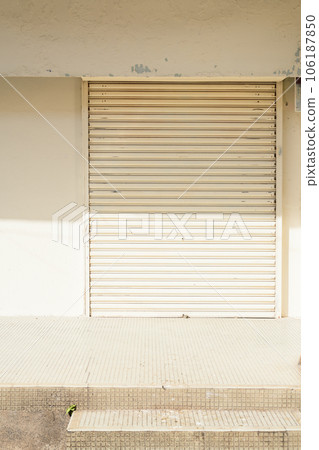 Closed beige shutter door and minimal architecture at Georgetown in Penang, Malaysia 106187850