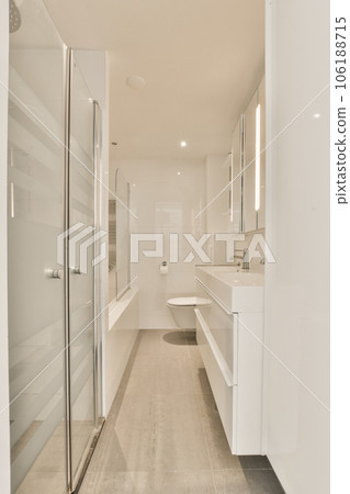 a bathroom with white walls and wood flooring in the shower area, while there is no glass doors on the door a bathroom with white walls and wood flooring in the shower area, while there is no glass doors on the door 106188715