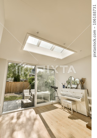 a living room with white furniture and an open door leading to the patio area that looks out onto the backyard 106188731