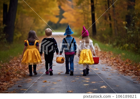 Young kids trick or treating during Halloween, back view 106189821