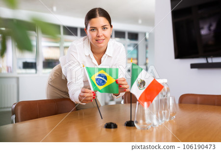 Young lady sets miniatures flags of Mexico and Brazil for international negotiations Young lady sets miniatures flags of Mexico and Brazil for international negotiations 106190473
