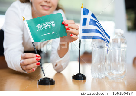 Young female secretary preparing room for international negotiations between greece and saudi arabia Young female secretary preparing room for international negotiations between greece and saudi arabia 106190487