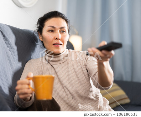 Asian woman watching TV at home 106190535