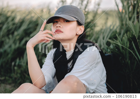 Backpacker woman resting in the grass Backpacker woman resting in the grass 106190813