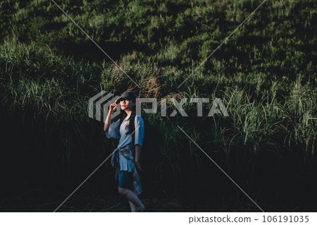 Backpacker woman walking in nature 106191035